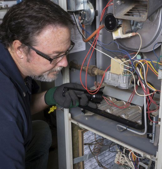 a Meyer & Depew technician working on a not-for-profit's HVAC system
