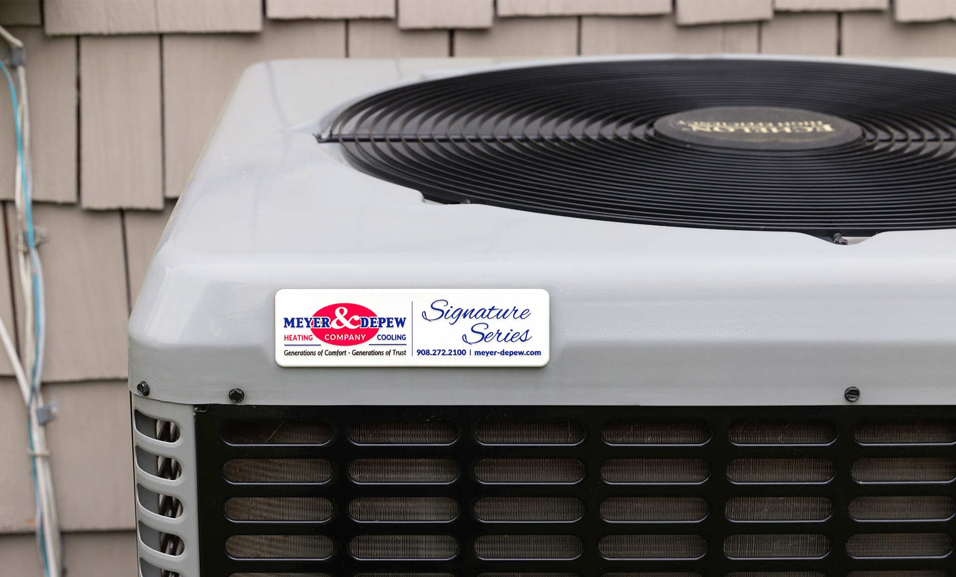 An air conditioner unit outside of a house featuring the Meyer and Depew logo.