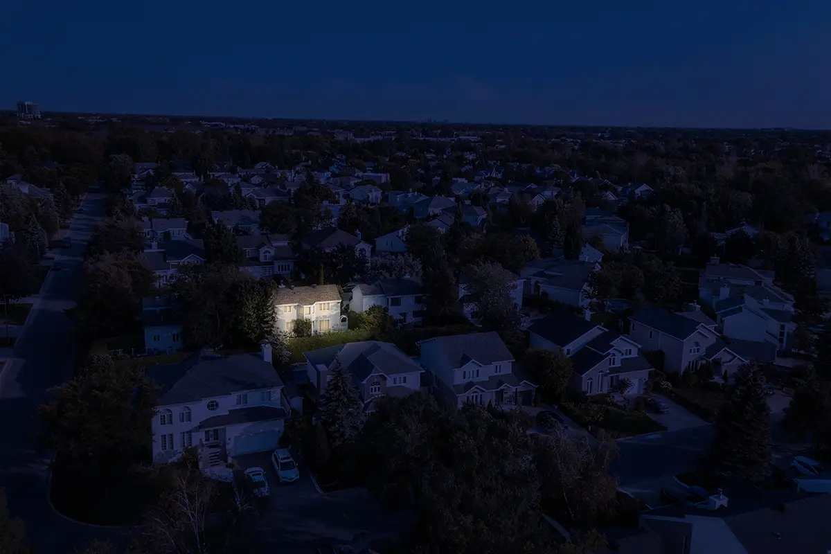 A home illuminated with power in a neighborhood that has lost power thanks to a whole-home generator.